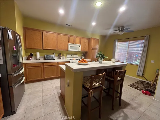a kitchen with a sink a counter top space appliances and cabinets