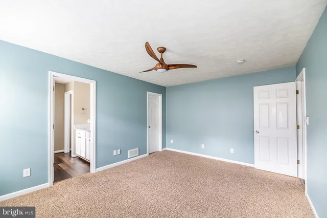 a view of a livingroom with a ceiling fan and window