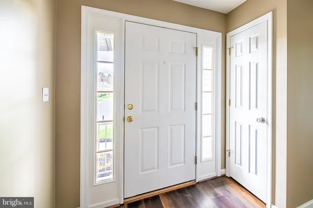a view of front door with wooden floor
