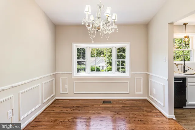 a view of an entryway with wooden floor and cabinet