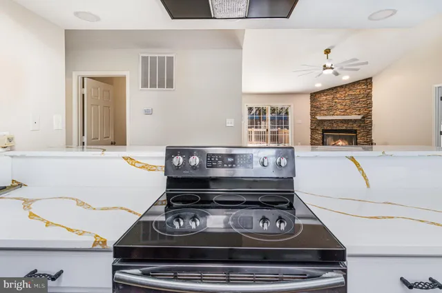 a living room with a stove and a window