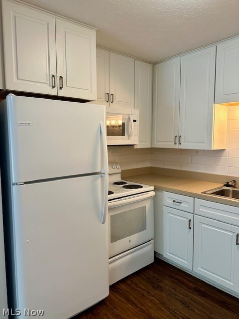 4376 Darrow Road, Unit 2 Stow, OH 44224 - Photo 11 of 26 Kitchen with white appliances, a sink, dark wood-style flooring, white cabinetry, and tasteful backsplash
