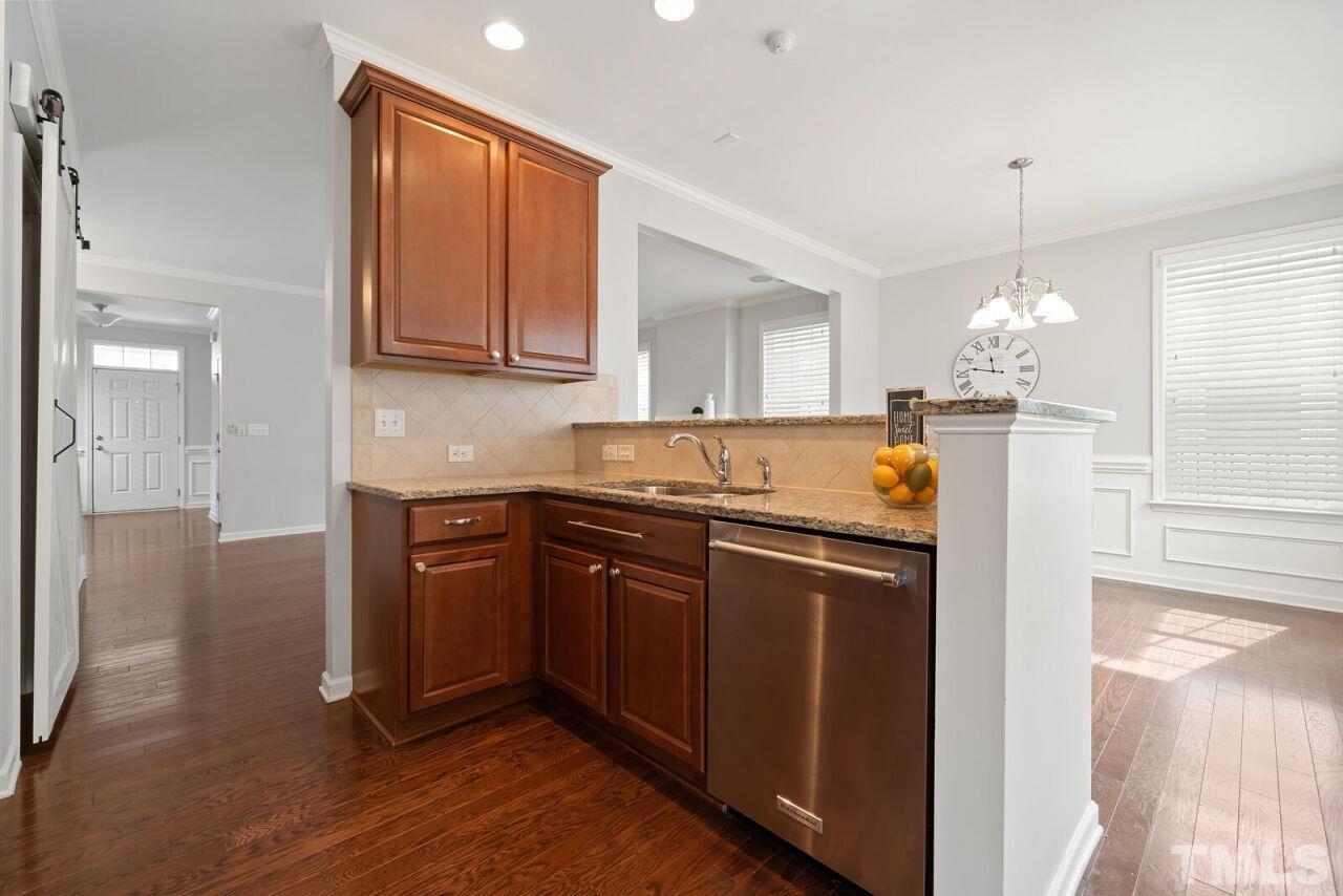1026 Ileagnes Road Raleigh, NC 27603 - Photo 11 of 29 a kitchen with a sink a refrigerator and wooden floor