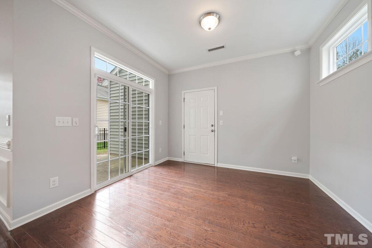 1026 Ileagnes Road Raleigh, NC 27603 - Photo 13 of 29 an empty room with wooden floor and windows