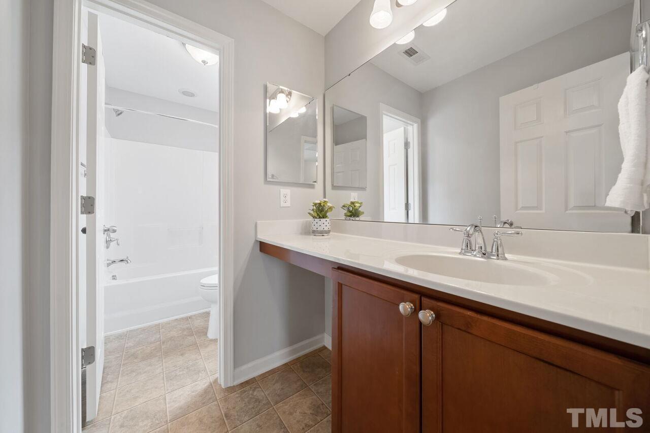 1026 Ileagnes Road Raleigh, NC 27603 - Photo 16 of 29 a bathroom with a sink and a mirror