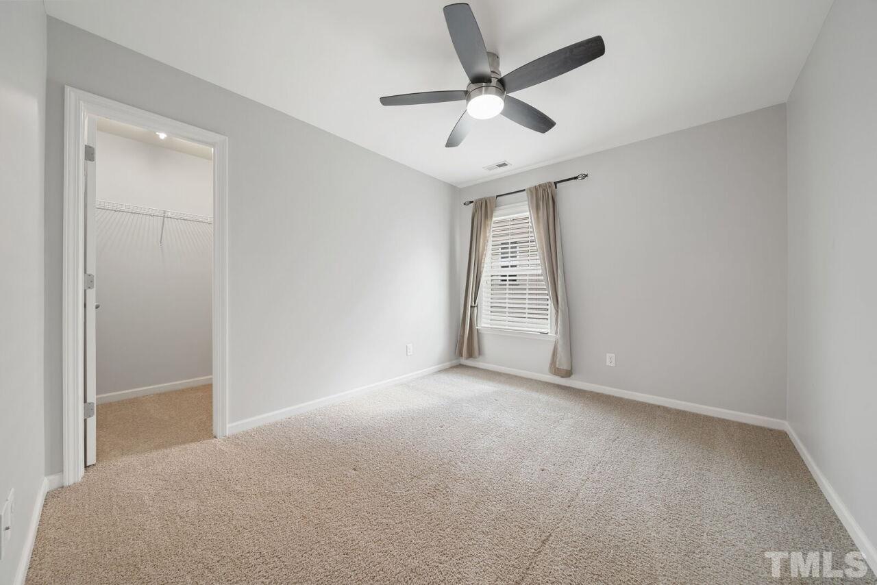 1026 Ileagnes Road Raleigh, NC 27603 - Photo 18 of 29 an empty room with windows and fan