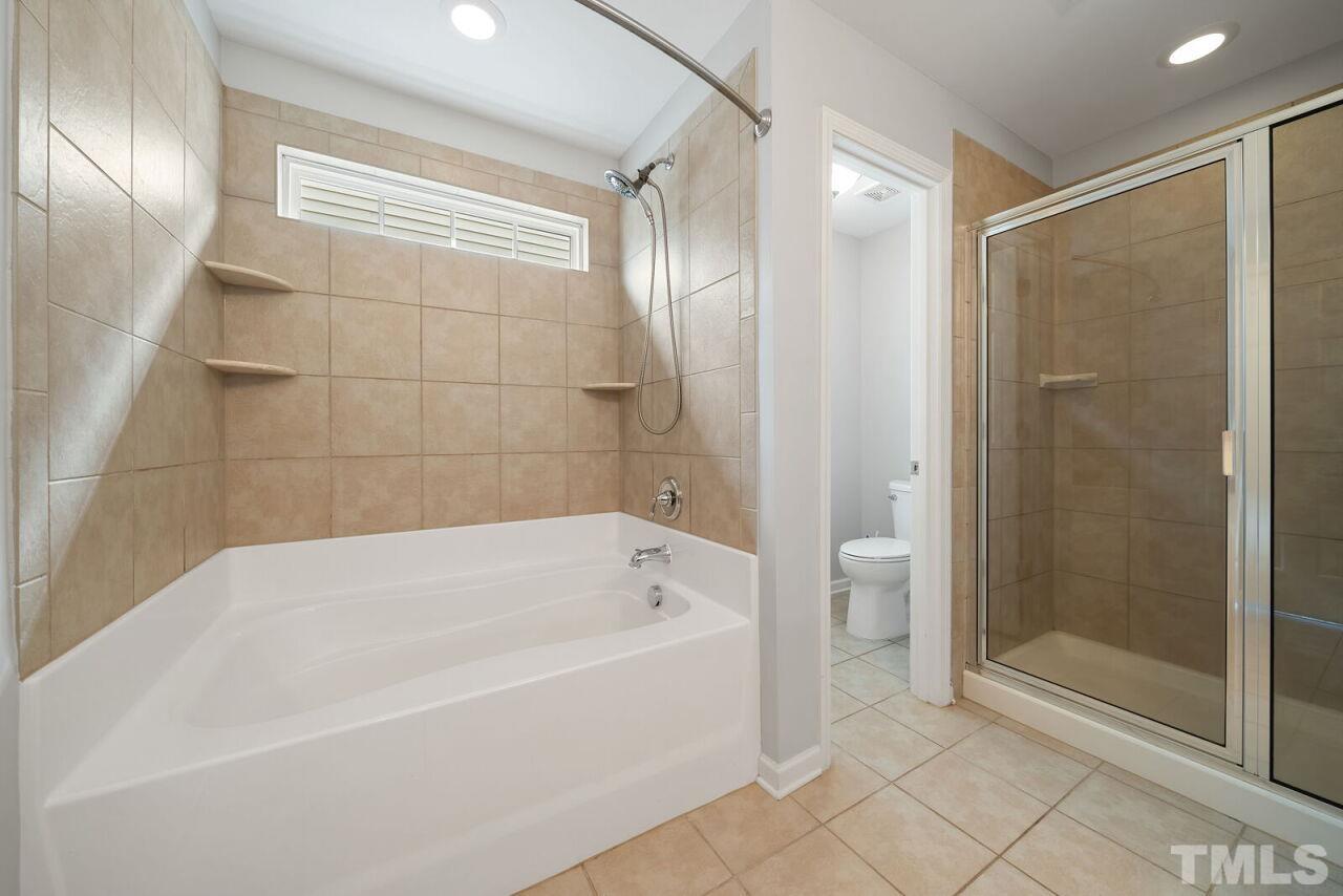 1026 Ileagnes Road Raleigh, NC 27603 - Photo 23 of 29 a bathroom with a bathtub and a shower