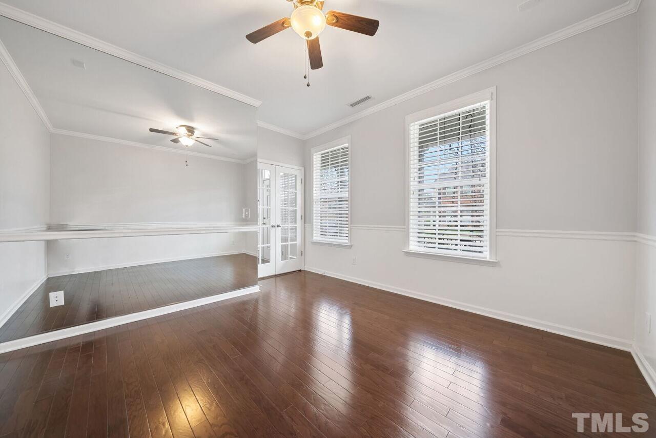 1026 Ileagnes Road Raleigh, NC 27603 - Photo 5 of 29 a view of an empty room with wooden floor and a window