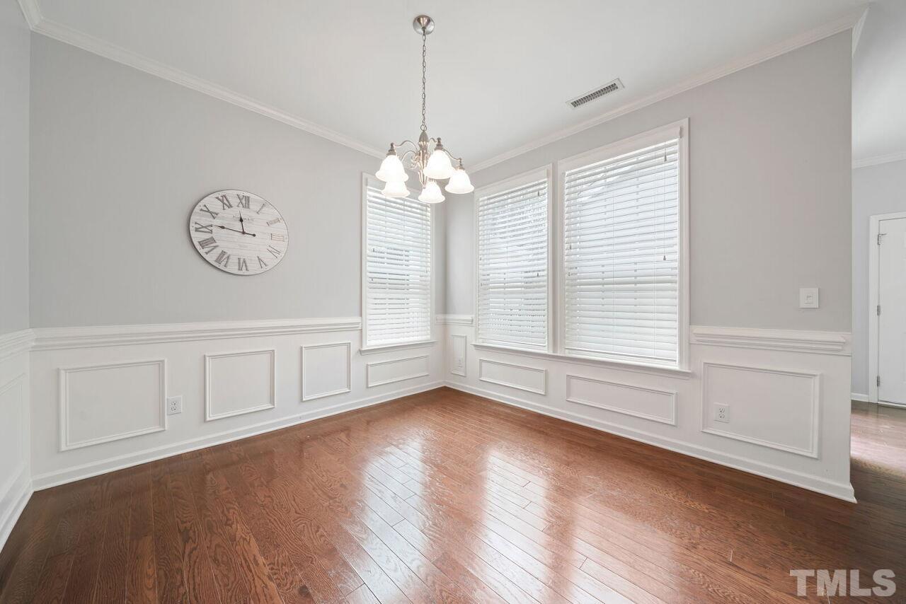 1026 Ileagnes Road Raleigh, NC 27603 - Photo 8 of 29 a view of an empty room with wooden floor and a window