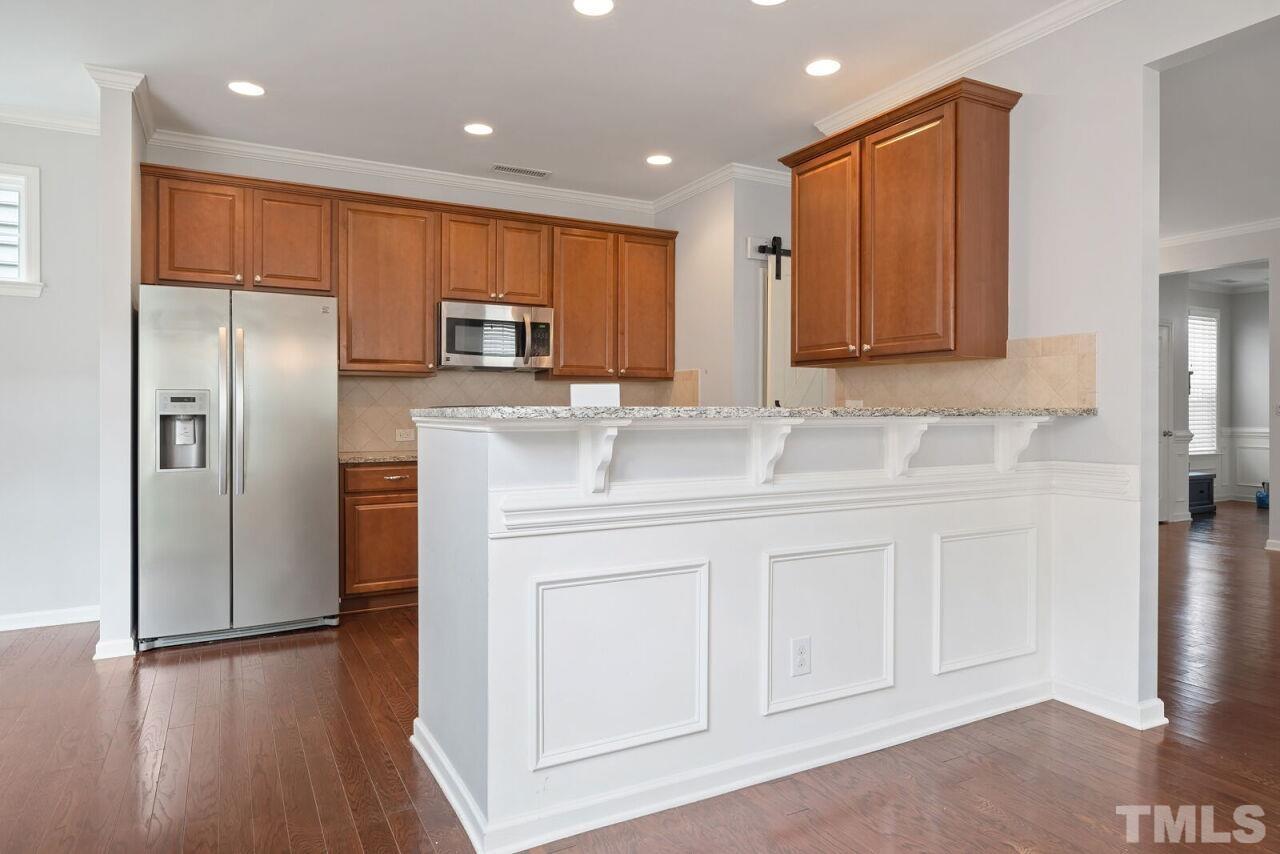 1026 Ileagnes Road Raleigh, NC 27603 - Photo 10 of 29 a kitchen with stainless steel appliances granite countertop a refrigerator and a sink