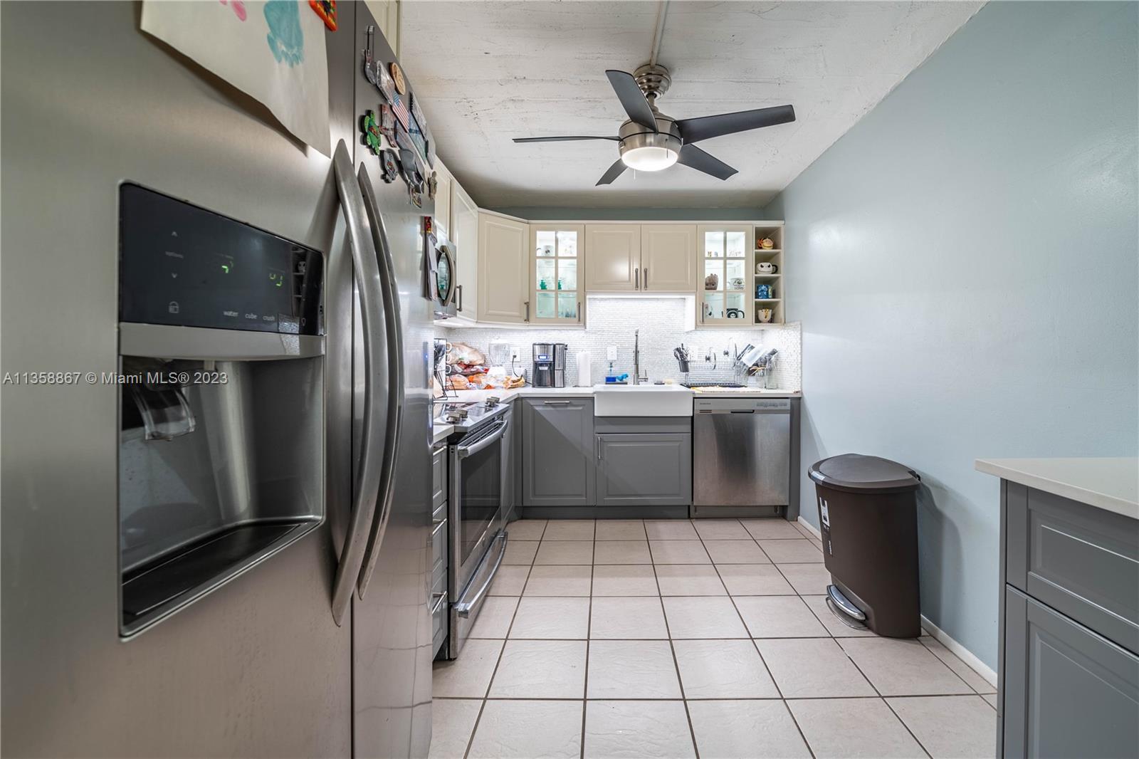 7300 Northwest 17th Street, Unit 314 Plantation, FL 33313 - Photo 1 of 30 a kitchen with a sink stainless steel appliances cabinets and a counter top space