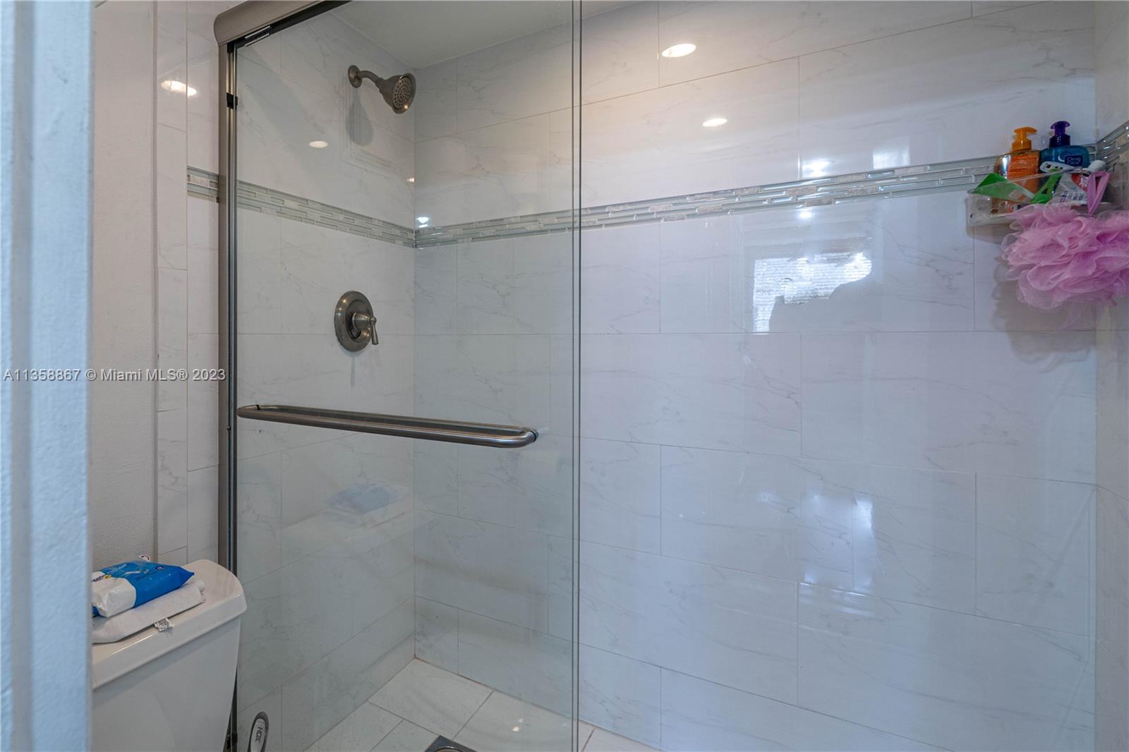 7300 Northwest 17th Street, Unit 314 Plantation, FL 33313 - Photo 11 of 30 a bathroom with a shower a toilet and sink