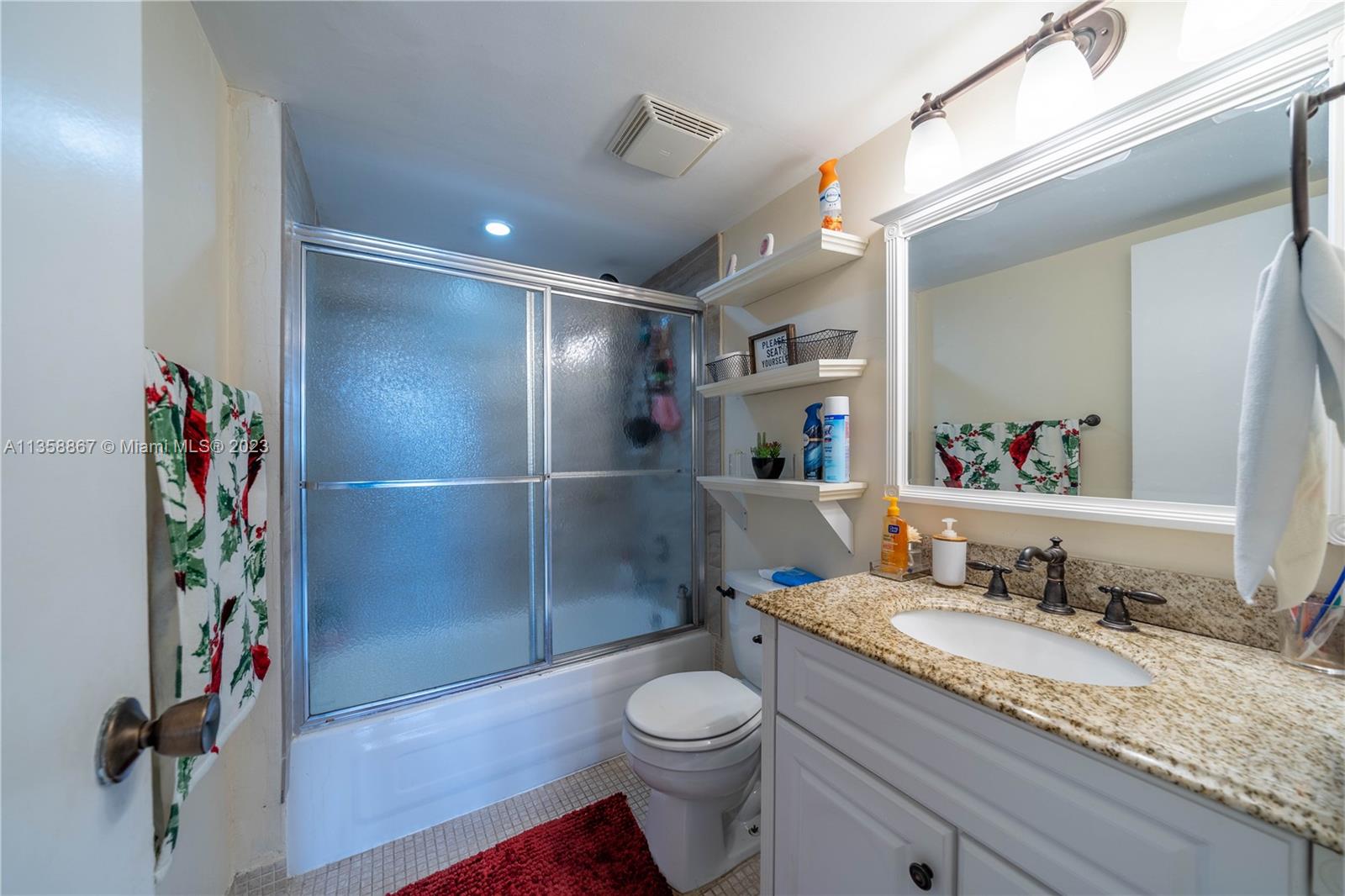 7300 Northwest 17th Street, Unit 314 Plantation, FL 33313 - Photo 17 of 30 a bathroom with a granite countertop sink toilet and shower