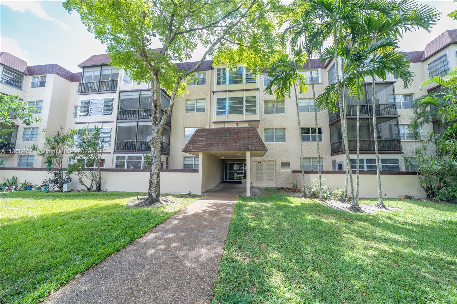 7300 Northwest 17th Street, Unit 314 Plantation, FL 33313 - Photo 19 of 30 a view of an house with backyard and a tree