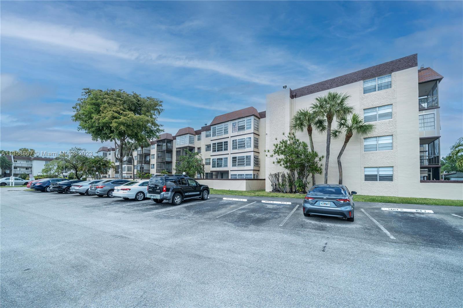 7300 Northwest 17th Street, Unit 314 Plantation, FL 33313 - Photo 20 of 30 a view of a cars parked in front of a house