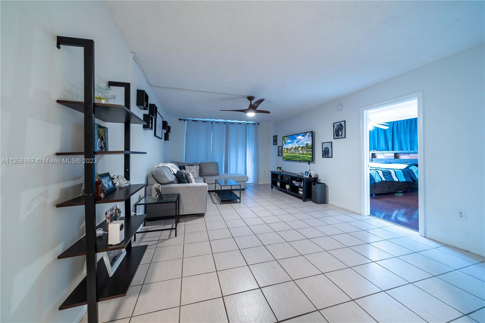 7300 Northwest 17th Street, Unit 314 Plantation, FL 33313 - Photo 5 of 30 a living room with furniture and a table