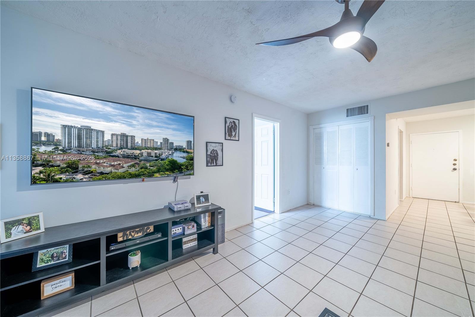 7300 Northwest 17th Street, Unit 314 Plantation, FL 33313 - Photo 6 of 30 a view of an empty room with kitchen natural light and hardwood floor