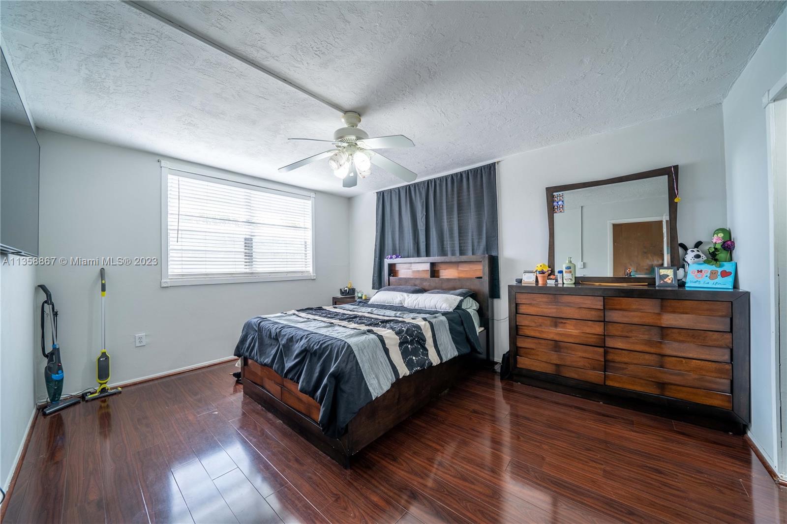 7300 Northwest 17th Street, Unit 314 Plantation, FL 33313 - Photo 7 of 30 a bedroom with a bed and a mirror on the dresser