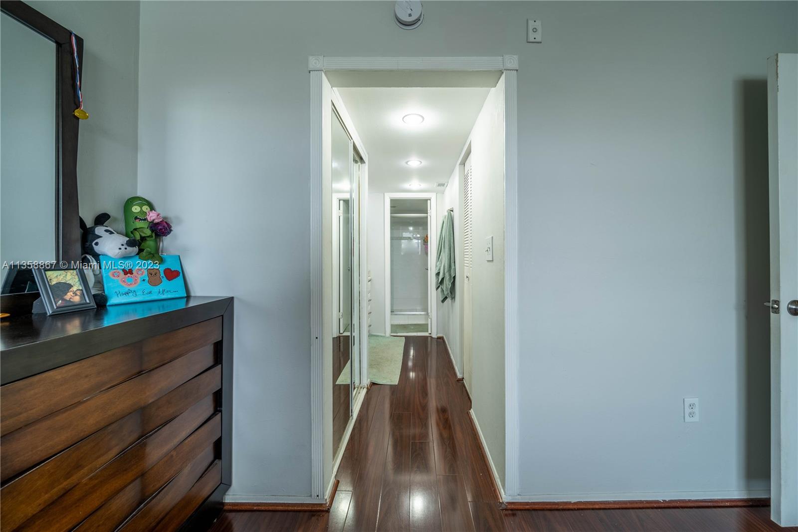 7300 Northwest 17th Street, Unit 314 Plantation, FL 33313 - Photo 9 of 30 a view of a hallway to a livingroom with wooden floor and furniture