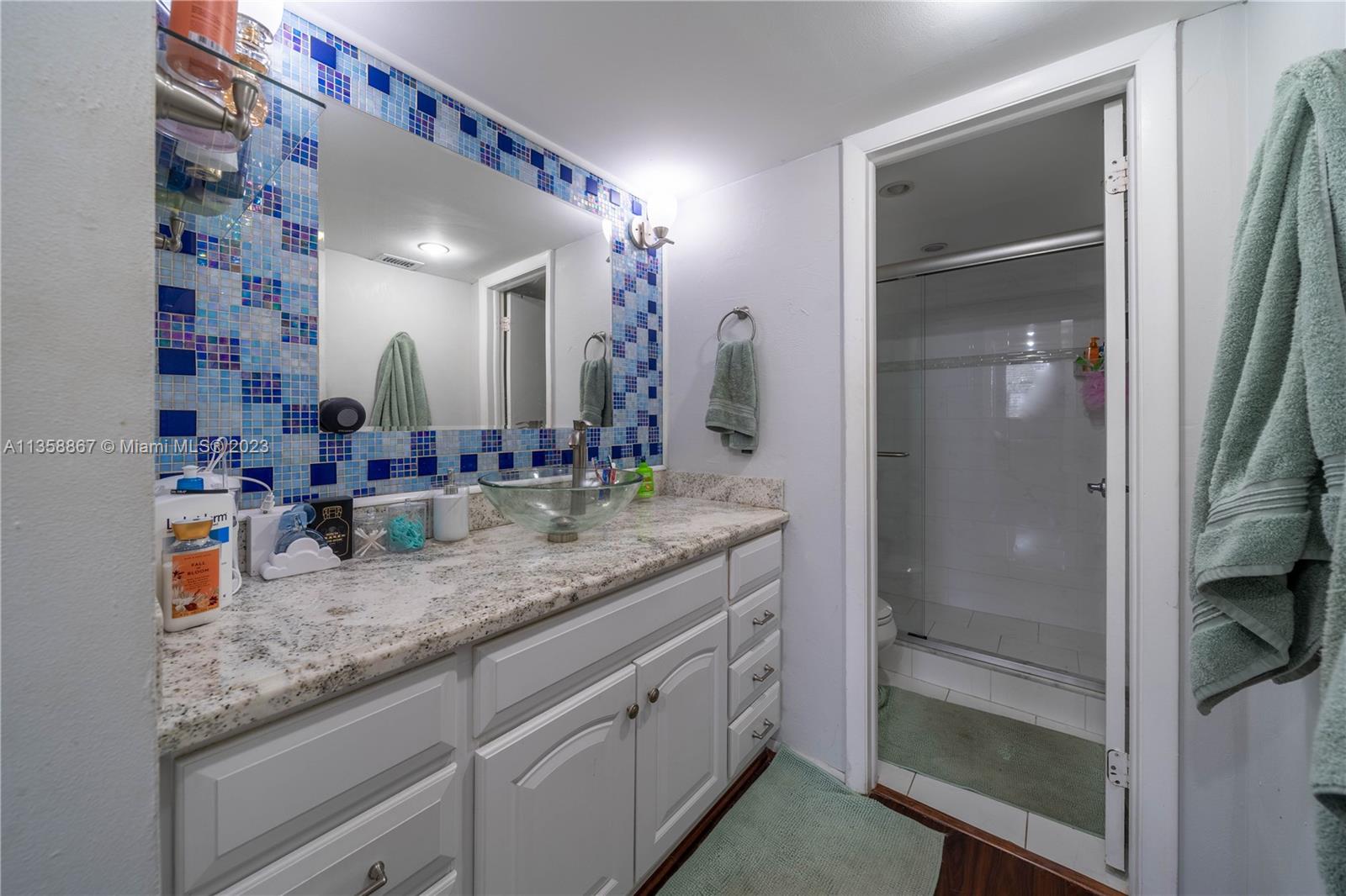 7300 Northwest 17th Street, Unit 314 Plantation, FL 33313 - Photo 10 of 30 a bathroom with a granite countertop sink and a mirror