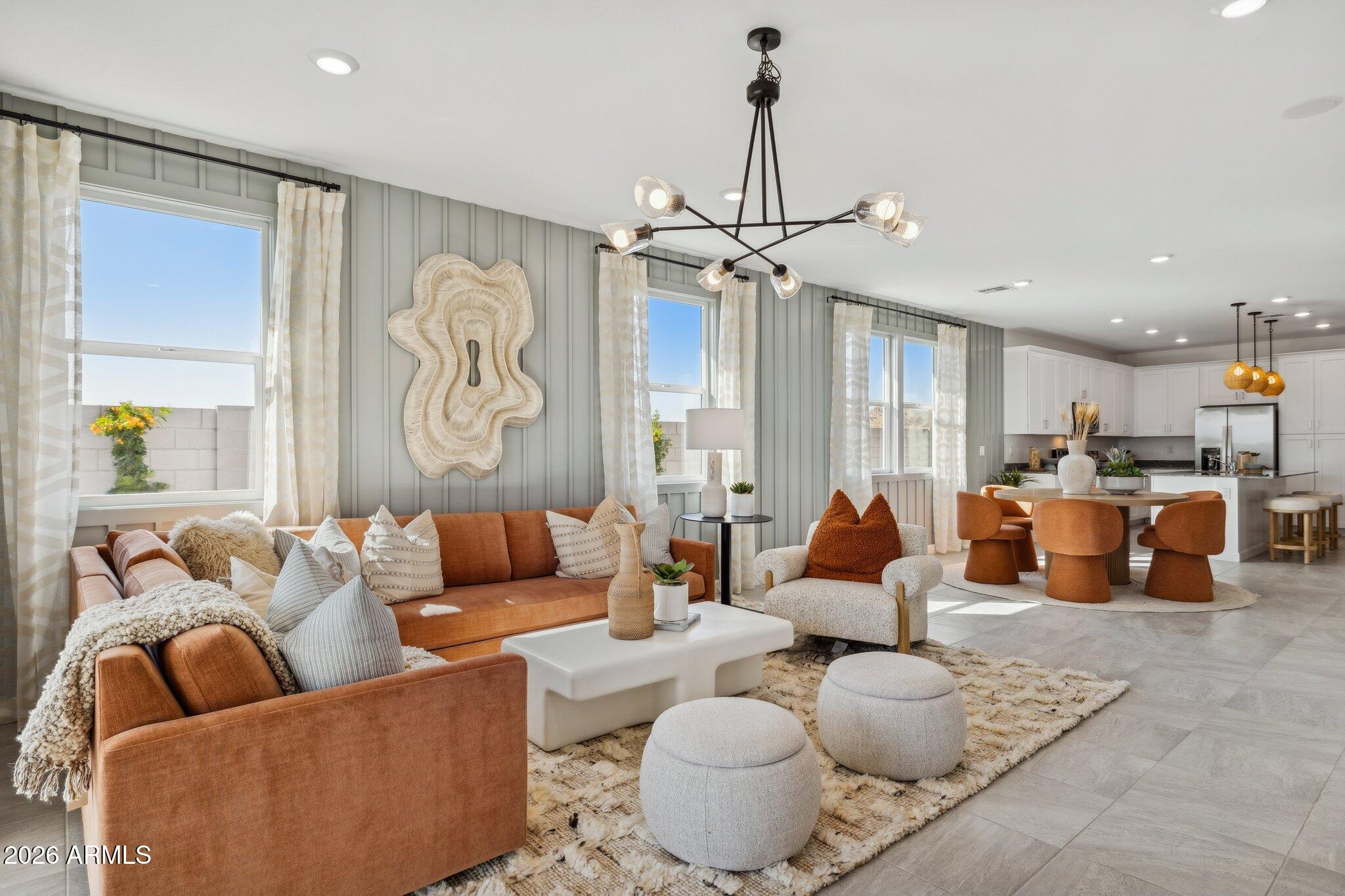 26449 West Crown King Road Buckeye, AZ 85326 - Photo 12 of 33 a living room with furniture kitchen view and a chandelier