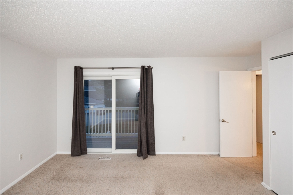 618 Edgebrook Drive, Unit 618 Boylston, MA 01505 - Photo 17 of 37 an empty room with sliding door and windows