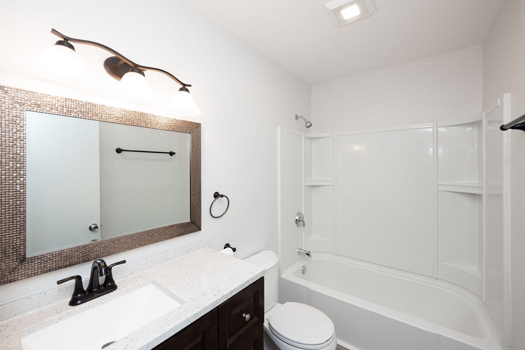 618 Edgebrook Drive, Unit 618 Boylston, MA 01505 - Photo 20 of 37 a bathroom with a bathtub shower sink vanity mirror and toilet