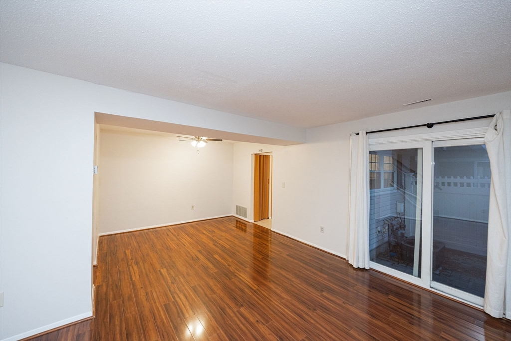 618 Edgebrook Drive, Unit 618 Boylston, MA 01505 - Photo 24 of 37 an empty room with wooden floor and windows