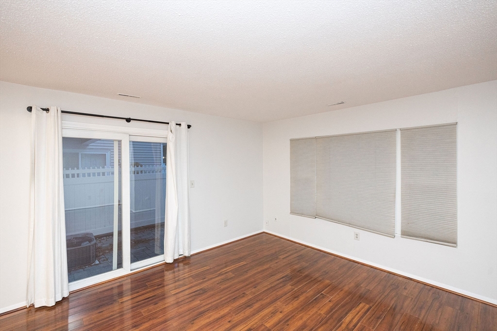 618 Edgebrook Drive, Unit 618 Boylston, MA 01505 - Photo 4 of 37 a view of an empty room with wooden floor and a window