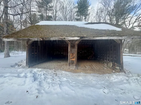 a front view of a house with a yard covered in snow