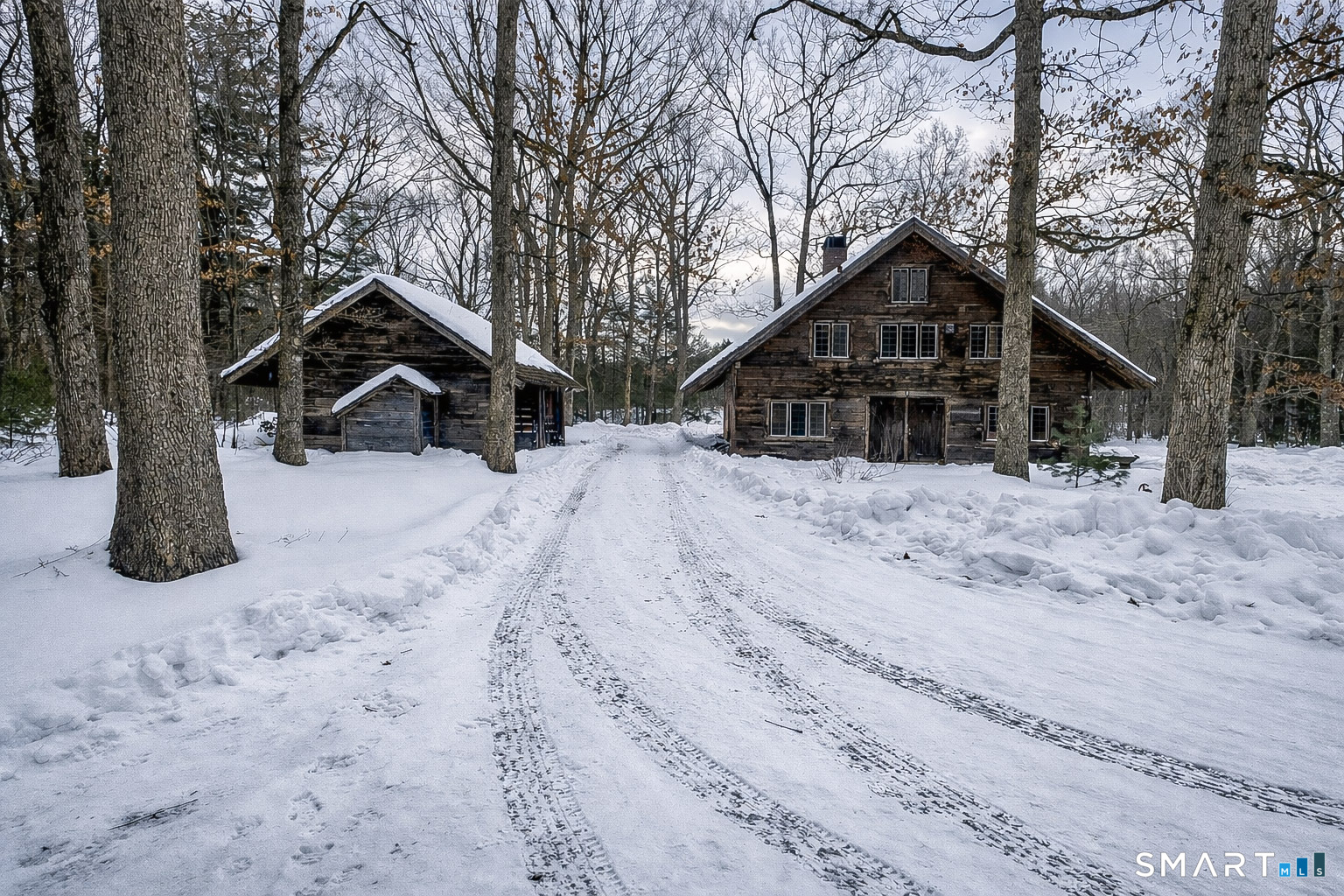 45 Hoppen Road, Unit MAIN New Hartford, CT 06057 - Photo 27 of 49 a front view of a house with a yard covered in snow