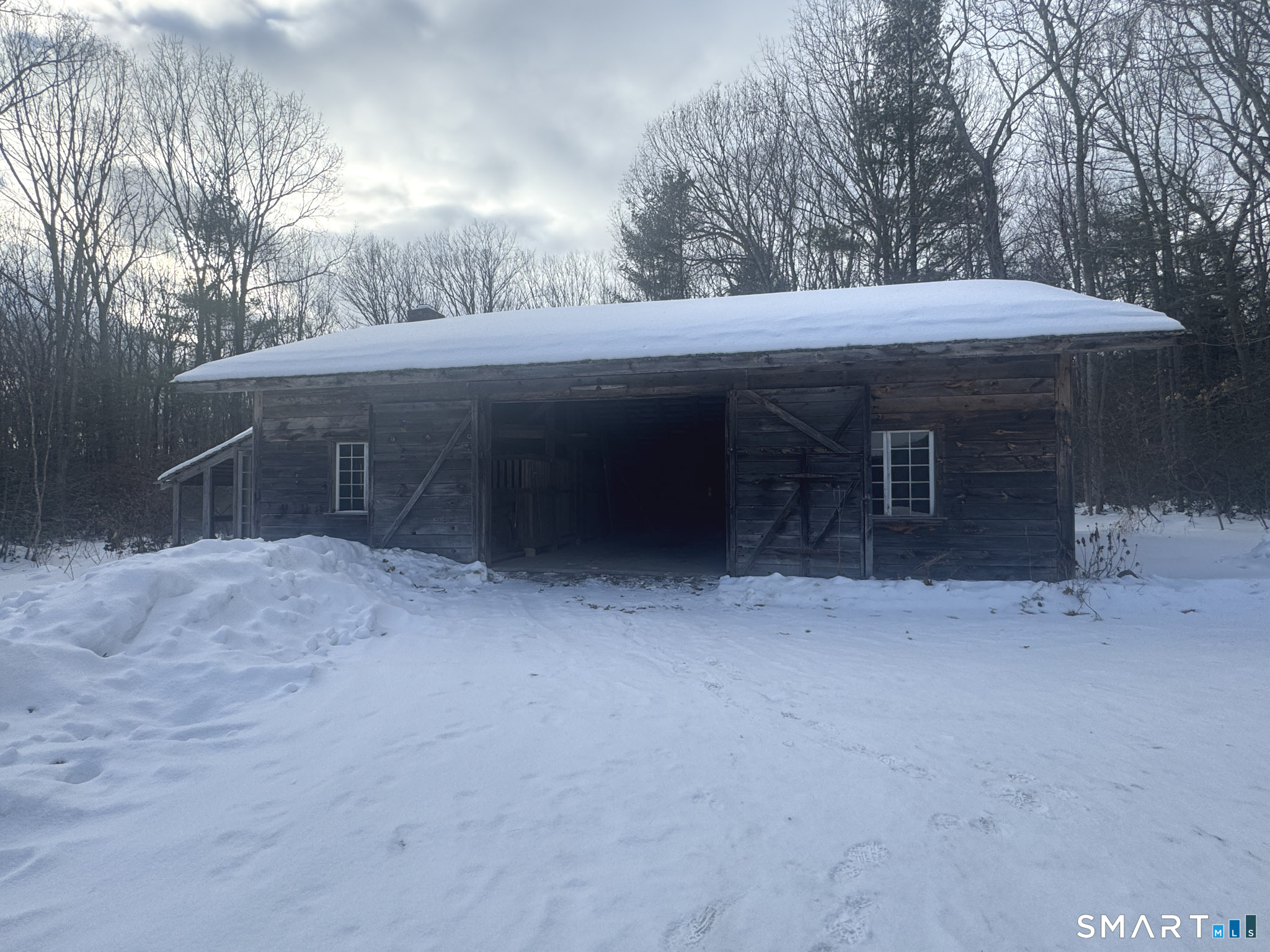 45 Hoppen Road, Unit MAIN New Hartford, CT 06057 - Photo 28 of 49 a view of a house with a yard and garage