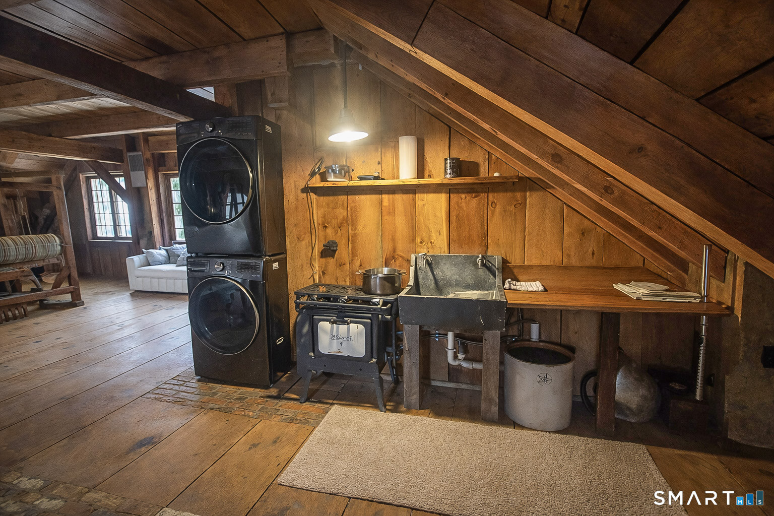 45 Hoppen Road, Unit MAIN New Hartford, CT 06057 - Photo 40 of 49 a living room with furniture a flat screen tv and a fireplace