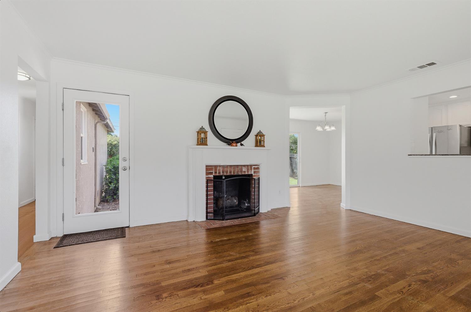 2511 Verna Way Sacramento, CA 95821 - Photo 11 of 34 a view of a livingroom with a fireplace wooden floor and window