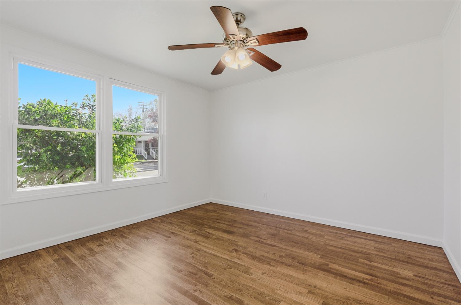 2511 Verna Way Sacramento, CA 95821 - Photo 13 of 34 an empty room with wooden floor fan and windows