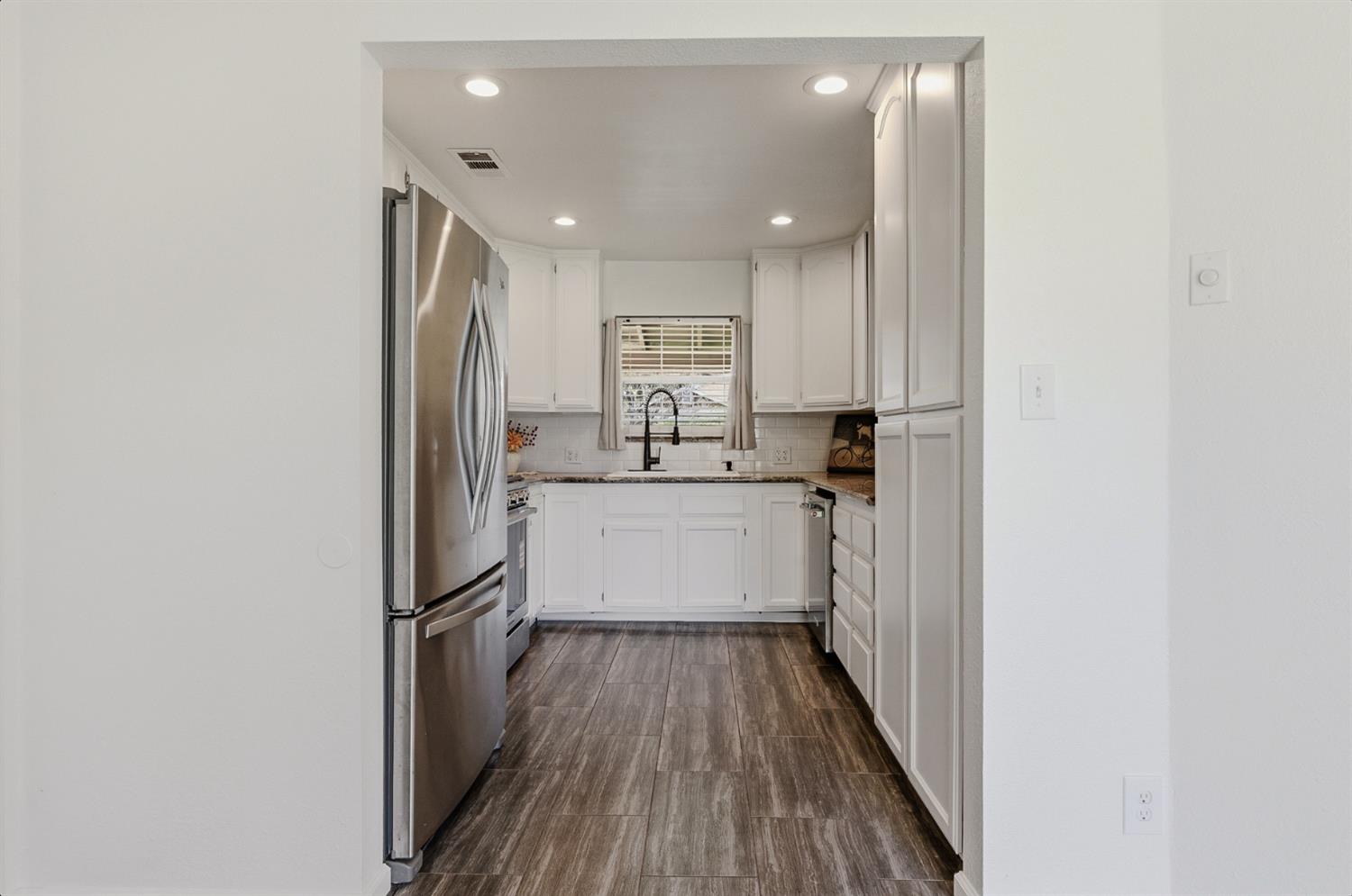 2511 Verna Way Sacramento, CA 95821 - Photo 17 of 34 a kitchen with a refrigerator sink and cabinets