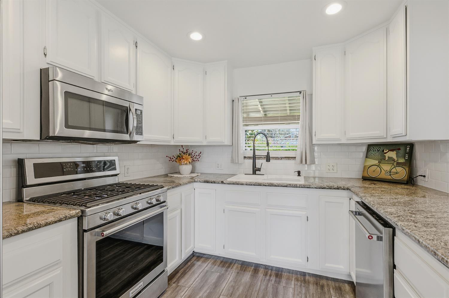 2511 Verna Way Sacramento, CA 95821 - Photo 18 of 34 a kitchen with granite countertop cabinets stainless steel appliances a sink and wooden floor