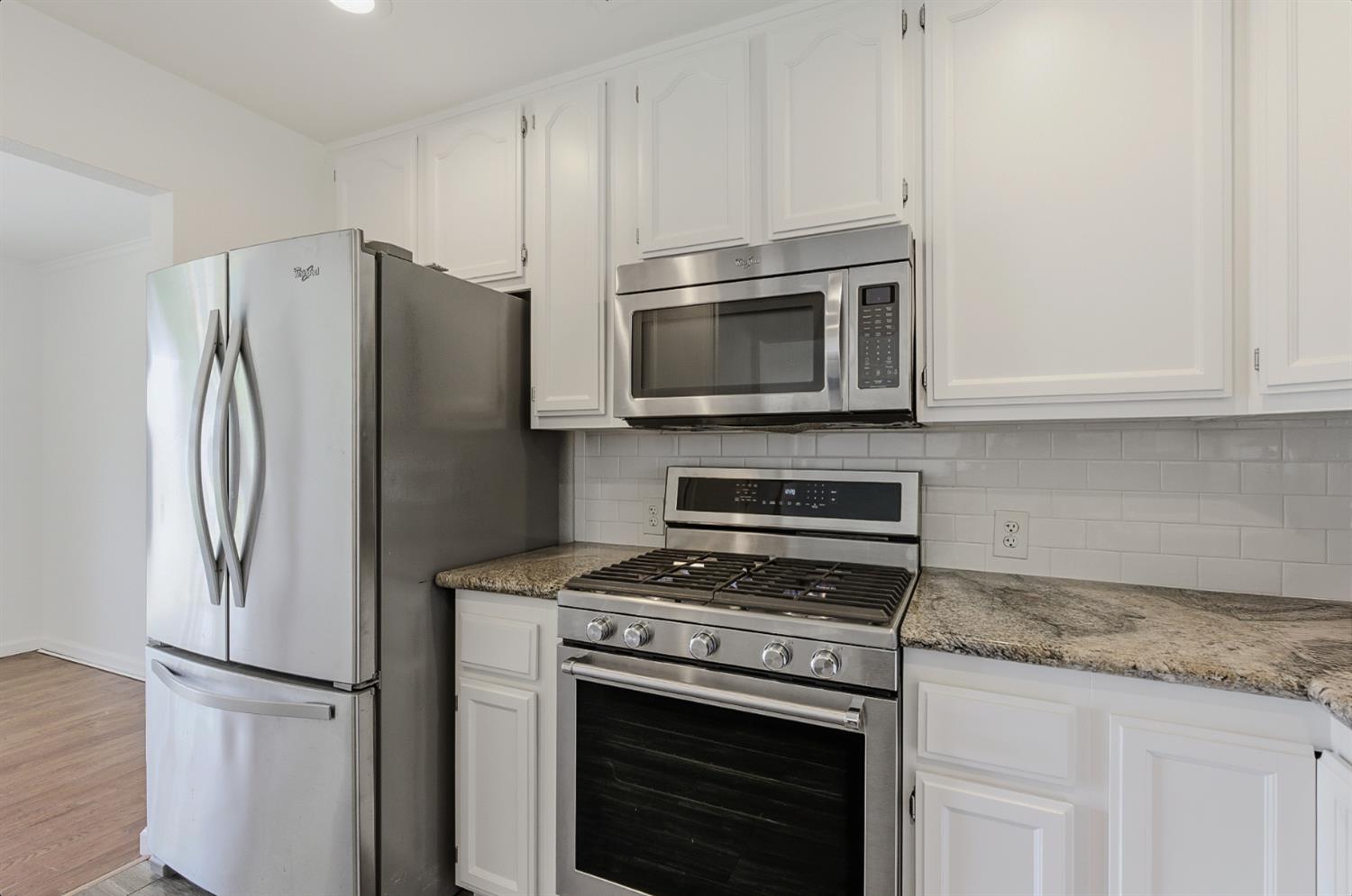 2511 Verna Way Sacramento, CA 95821 - Photo 19 of 34 a kitchen with stainless steel appliances white cabinets white stove a microwave and a refrigerator