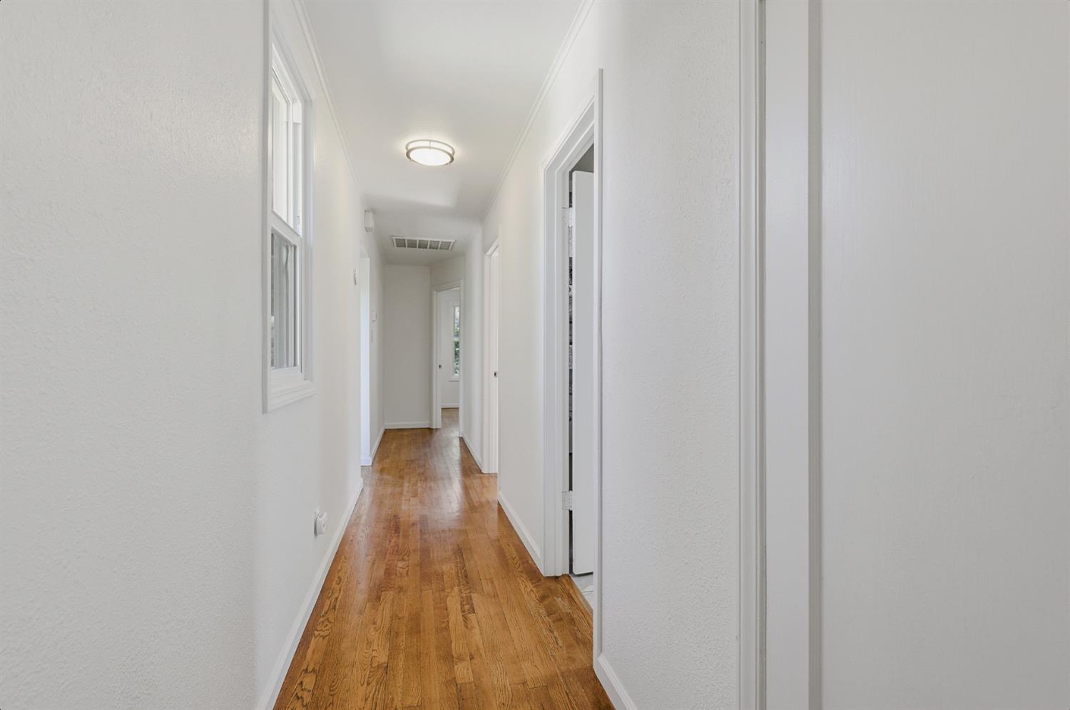 2511 Verna Way Sacramento, CA 95821 - Photo 21 of 34 a view of a hallway with wooden floor and a bathroom