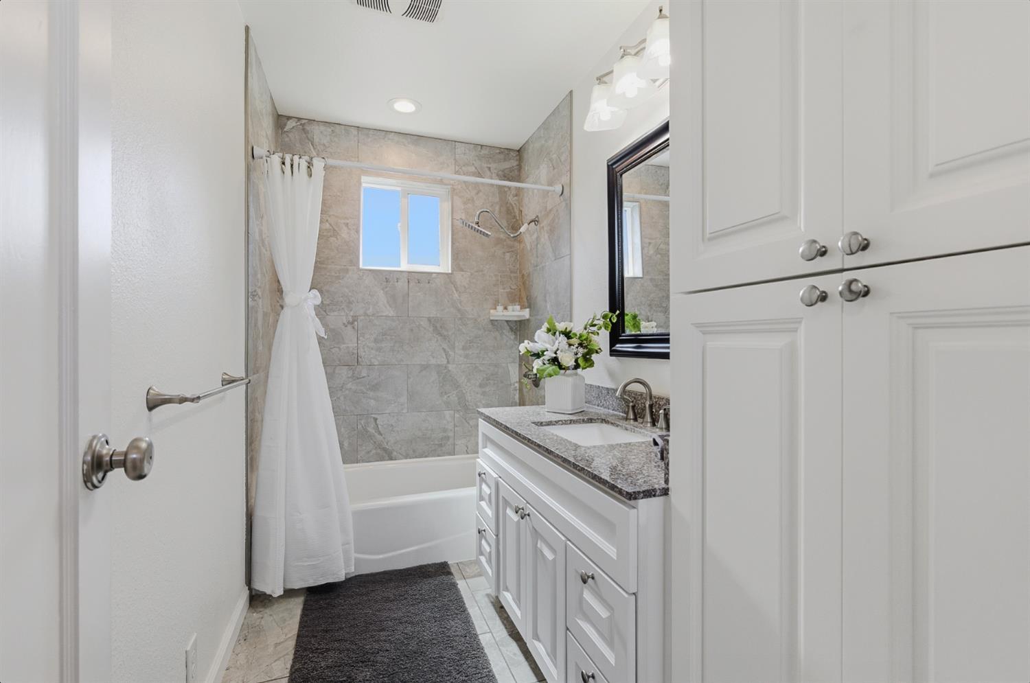 2511 Verna Way Sacramento, CA 95821 - Photo 25 of 34 a bathroom with a granite countertop sink a toilet and shower
