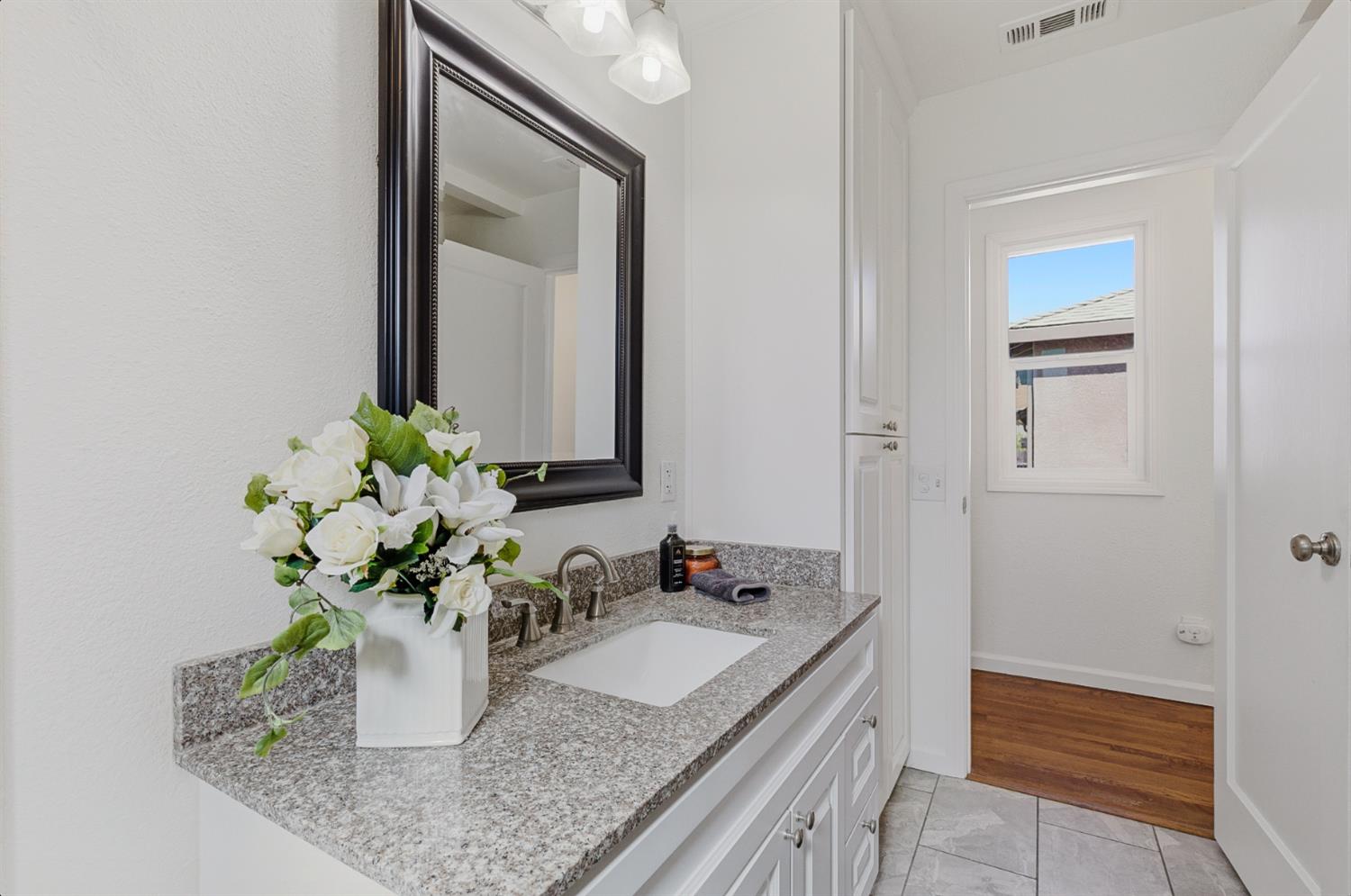 2511 Verna Way Sacramento, CA 95821 - Photo 26 of 34 a bathroom with a granite countertop sink a mirror and a potted plant