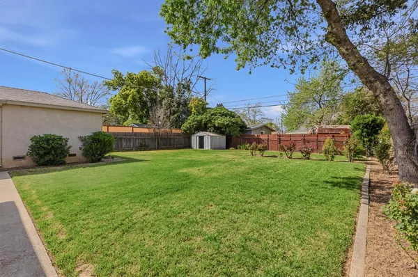a view of house with backyard space and garden