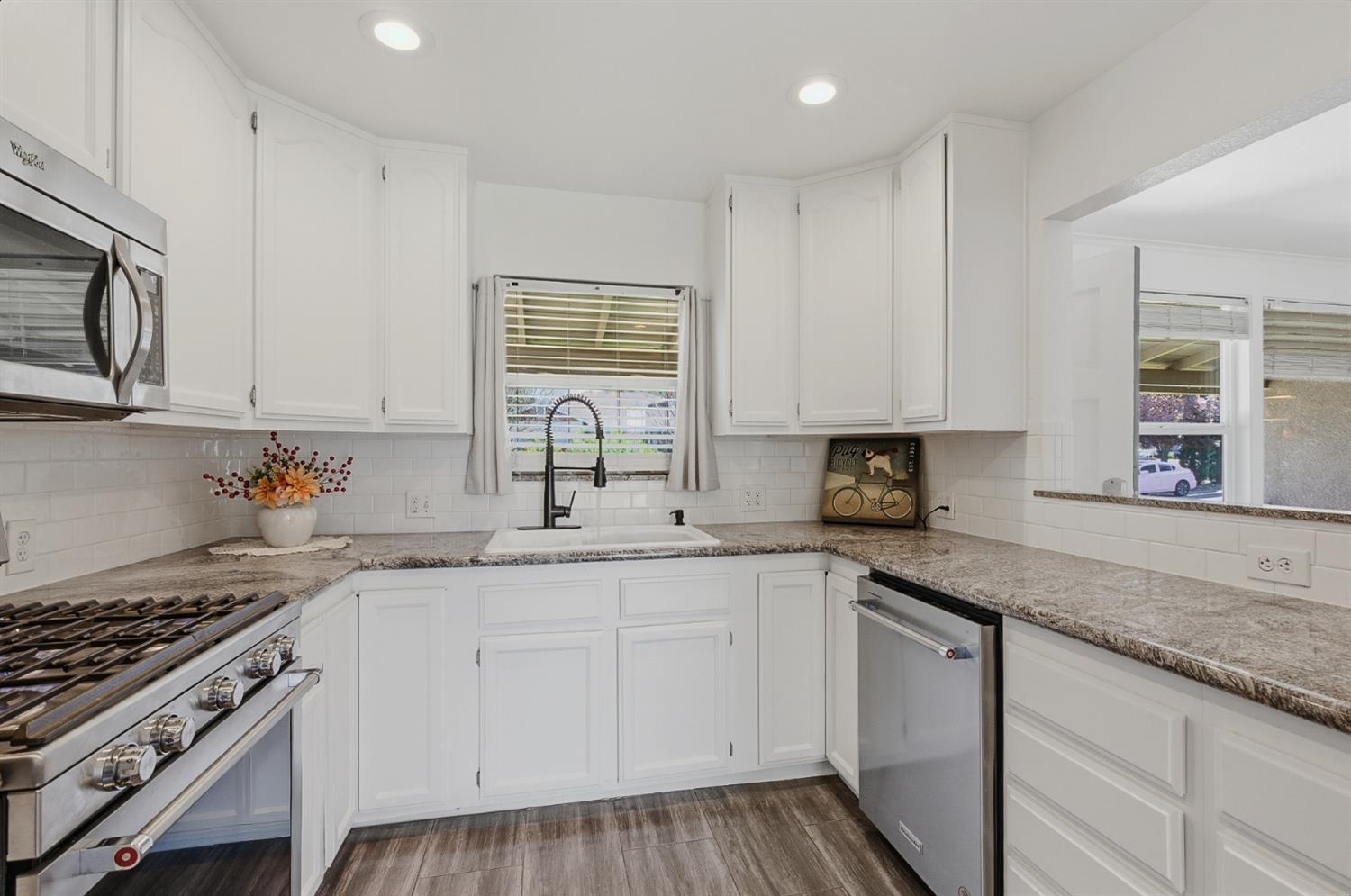 2511 Verna Way Sacramento, CA 95821 - Photo 5 of 34 a kitchen with granite countertop a sink stove and cabinets