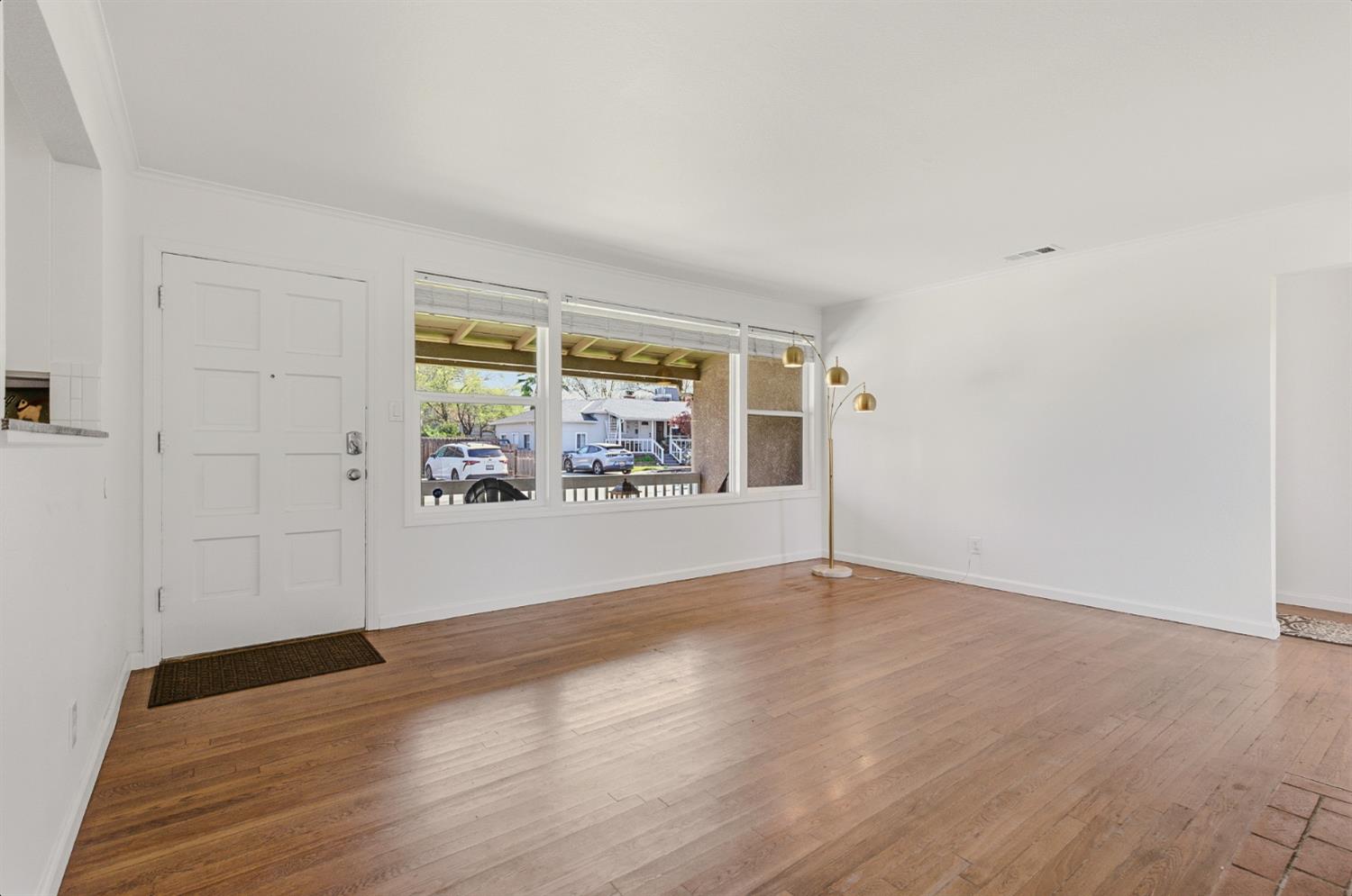 2511 Verna Way Sacramento, CA 95821 - Photo 10 of 34 an empty room with wooden floor and windows
