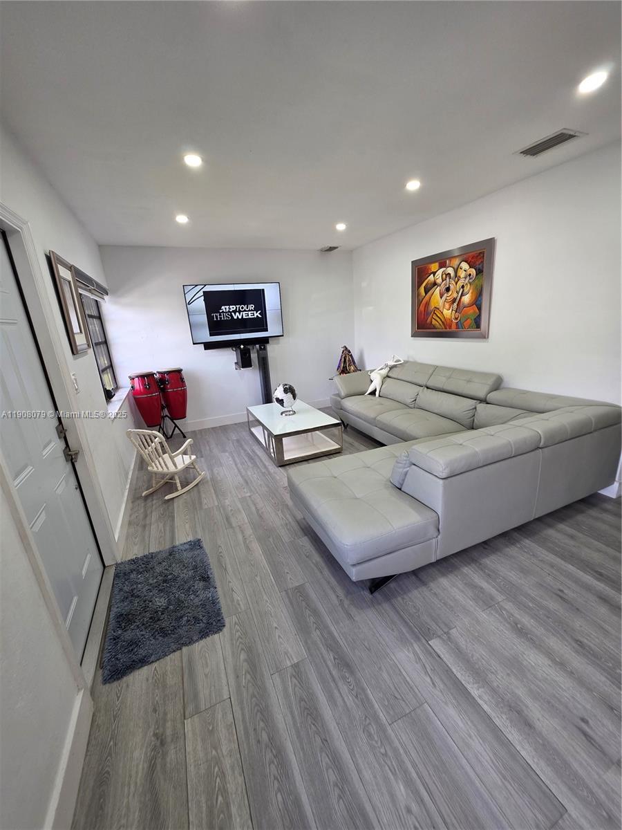 18200 Southwest 262nd Street Homestead, FL 33031 - Photo 11 of 30 a living room with furniture and a wooden floor