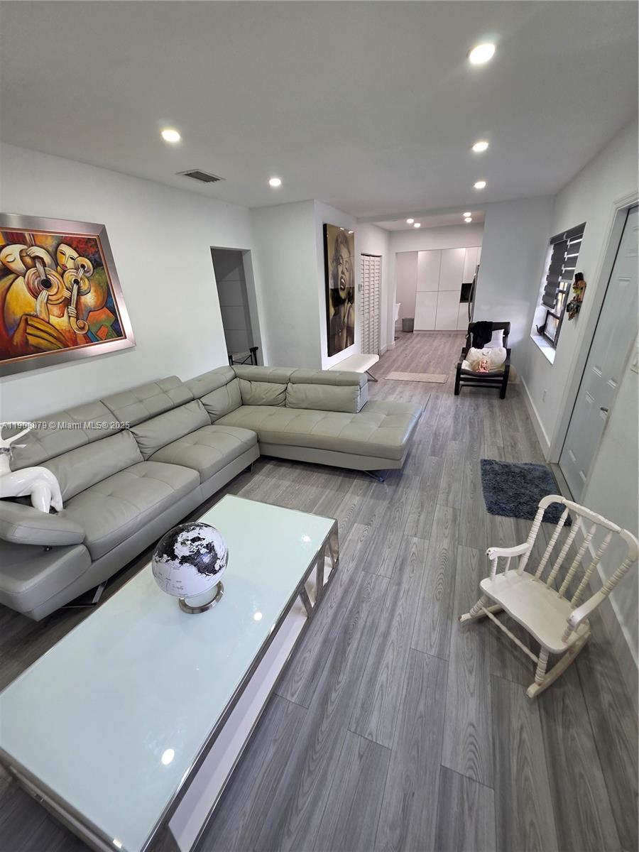 18200 Southwest 262nd Street Homestead, FL 33031 - Photo 12 of 30 a living room with furniture and wooden floor