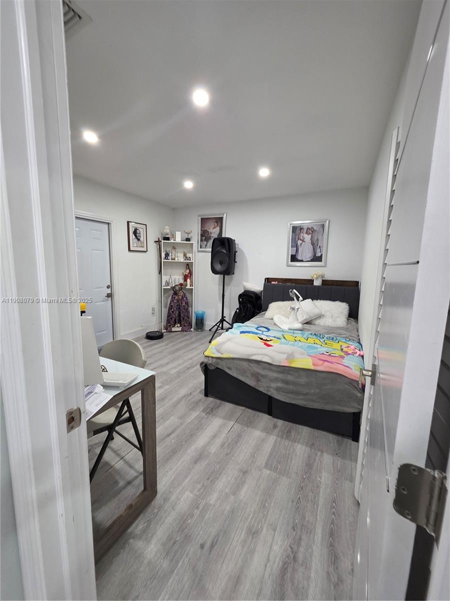 18200 Southwest 262nd Street Homestead, FL 33031 - Photo 13 of 30 a bedroom with a bed and a table in it