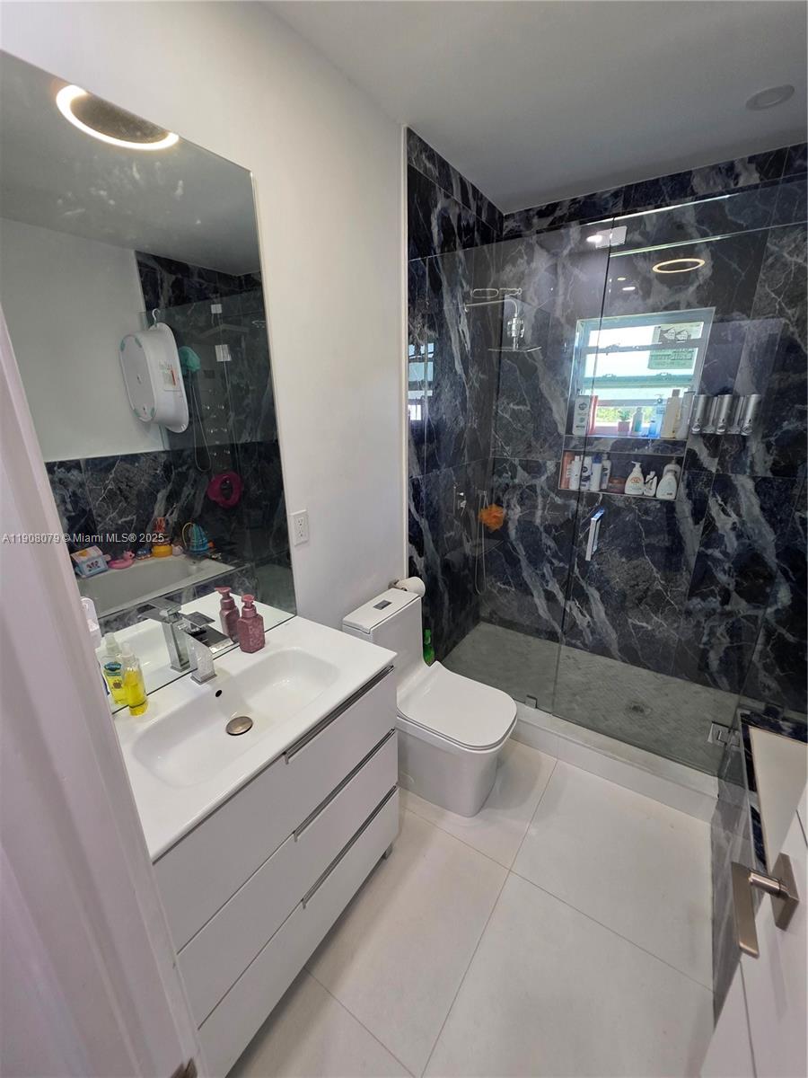 18200 Southwest 262nd Street Homestead, FL 33031 - Photo 14 of 30 a bathroom with a sink a toilet and shower