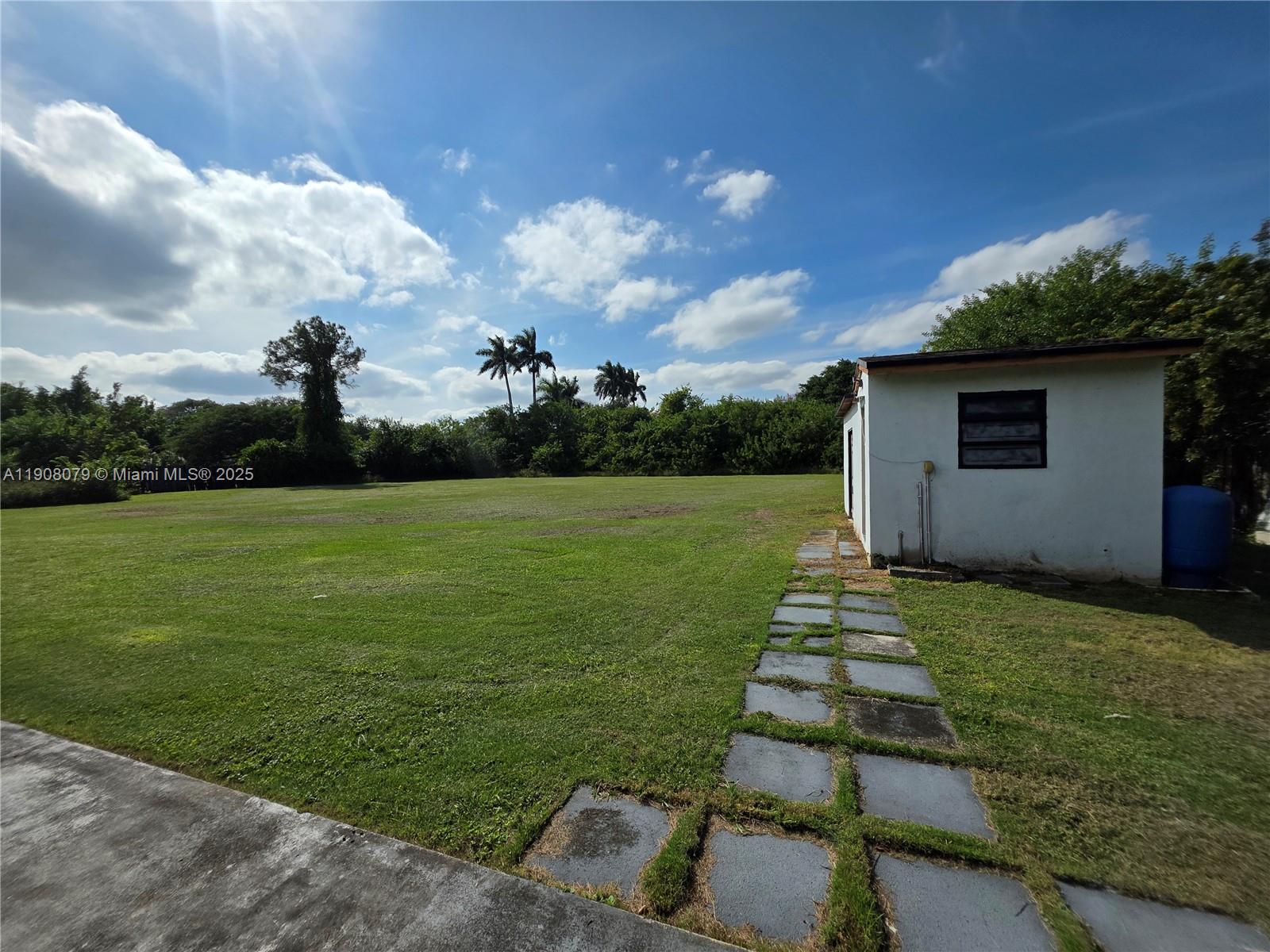18200 Southwest 262nd Street Homestead, FL 33031 - Photo 21 of 30 a front view of a house with a yard
