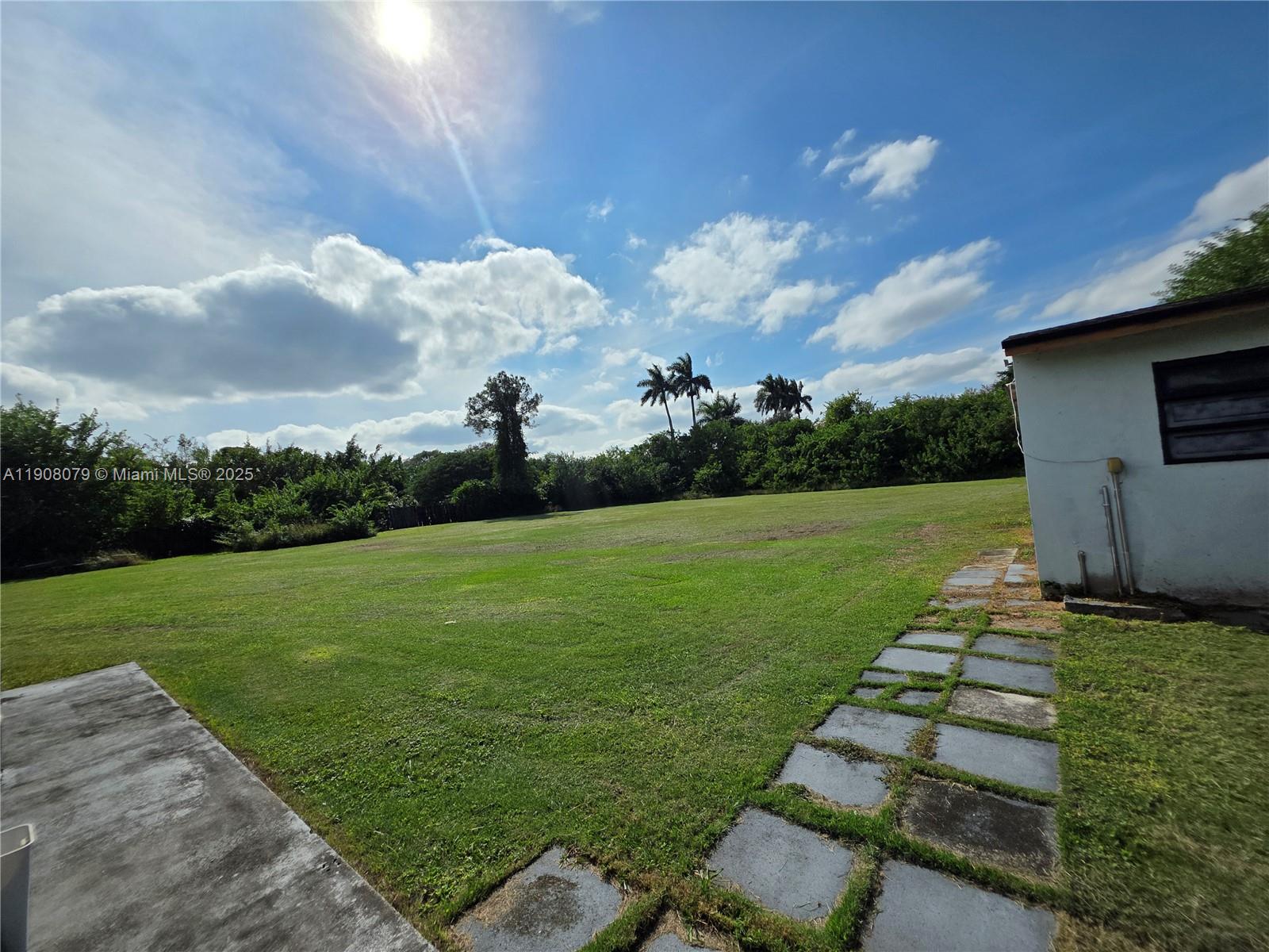 18200 Southwest 262nd Street Homestead, FL 33031 - Photo 22 of 30 a backyard of a house with lots of green space